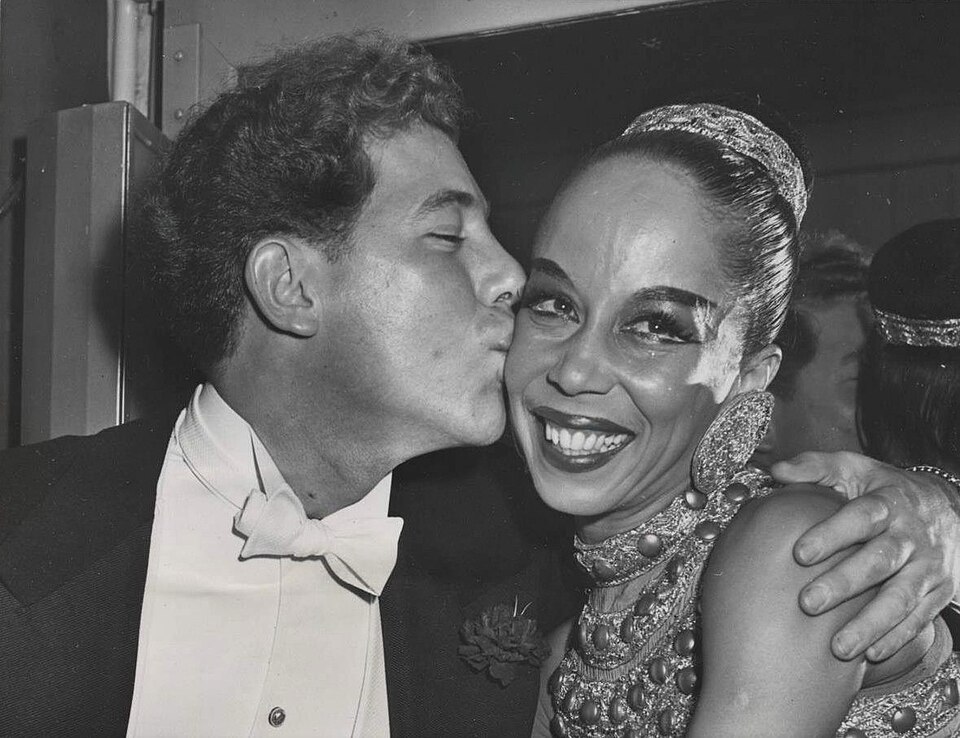 Janet Collins receiving a kiss from Zachary Solov, 1951